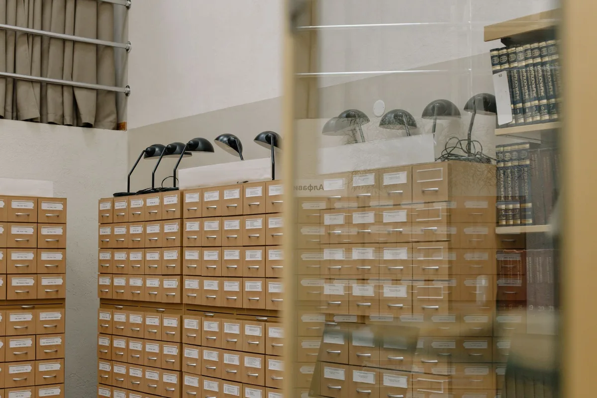 Vintage library card catalog with classic lamps, symbolizing knowledge and organization.