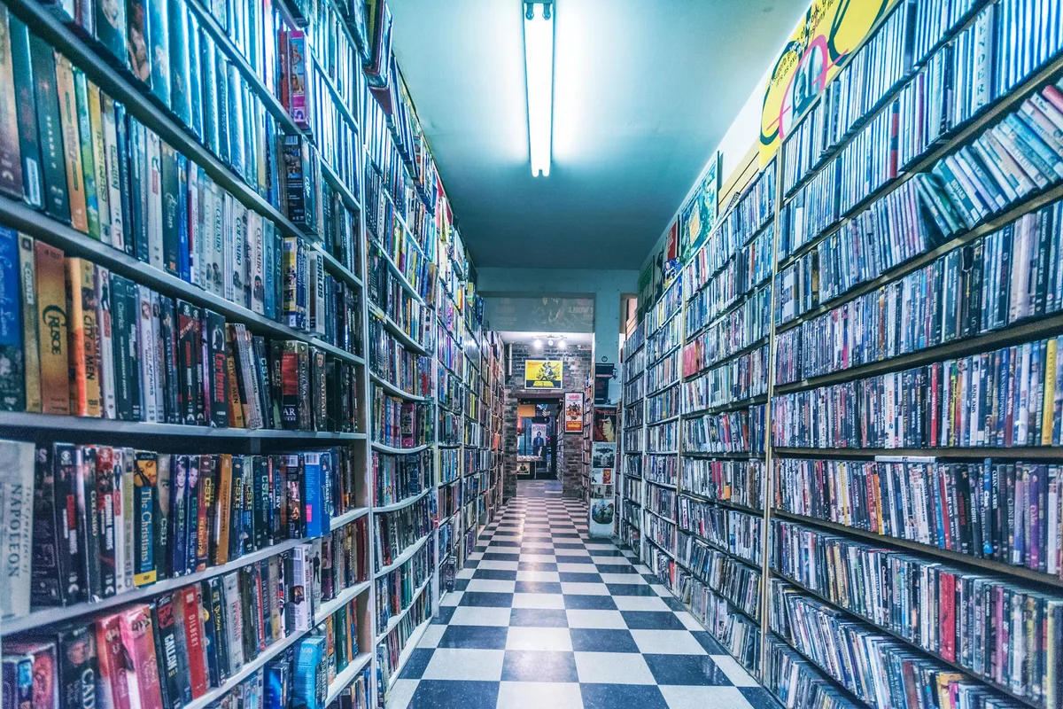 Explore a nostalgic video store aisle filled with classic VHS tapes, capturing retro vibes.