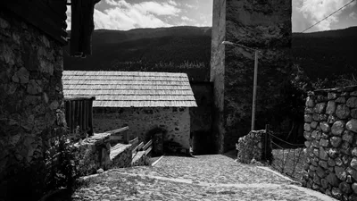 Black and white photo of a cobblestone street in the historic village of Mestia, Georgia.