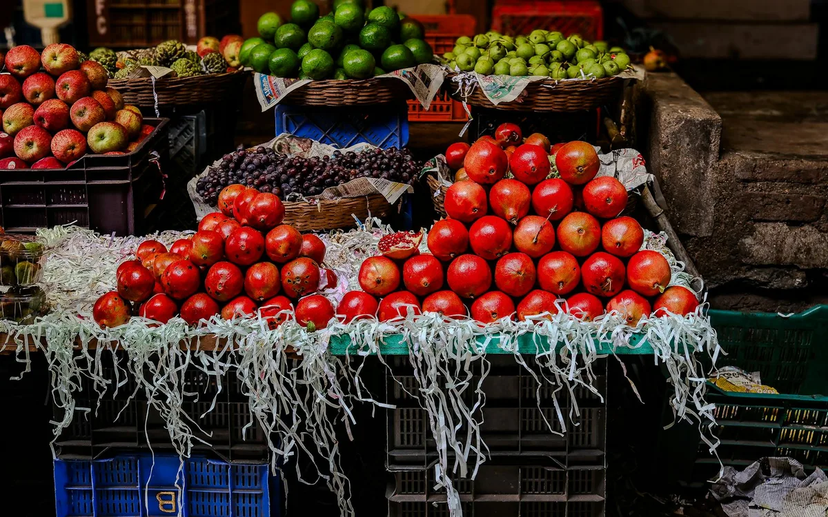 A vibrant display of assorted fruits in a lively market setting.