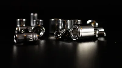 Detailed view of chrome metallic socket tools against a dark background showcasing precision and craftsmanship.
